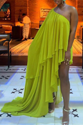 Woman wearing a bright green one-shoulder dress in an indoor setting.